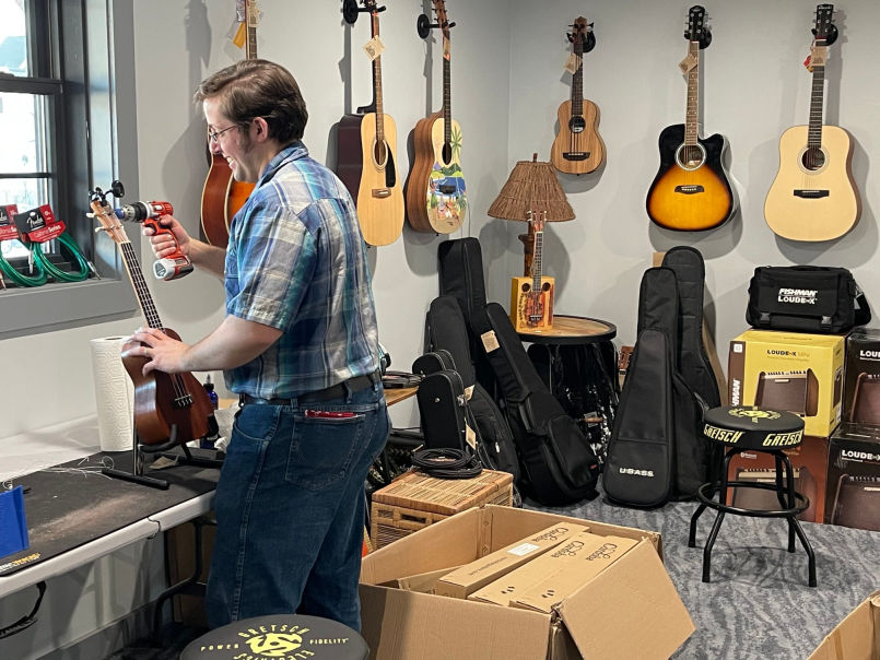 staff technician repairing musical instrument